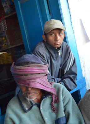 elderly Nepali man with scarf covering his eyes