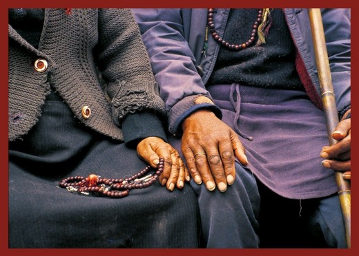 Photo of Tibetan refugee couple touching hands