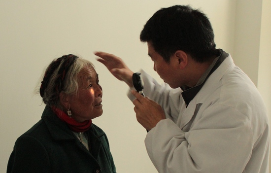 Tibetan ophthalmologist examining an elderly female patient