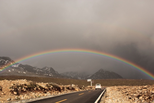 rainbow over the highway in the mountains of Tibet