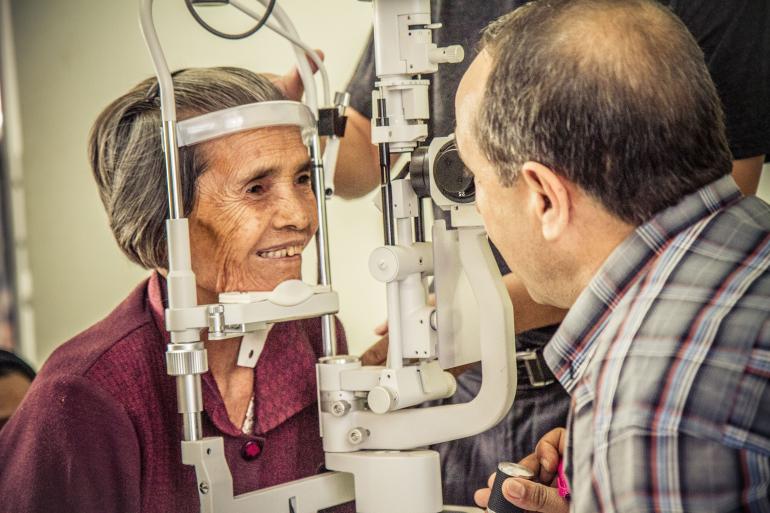 cambodian woman getting eyes examined 
