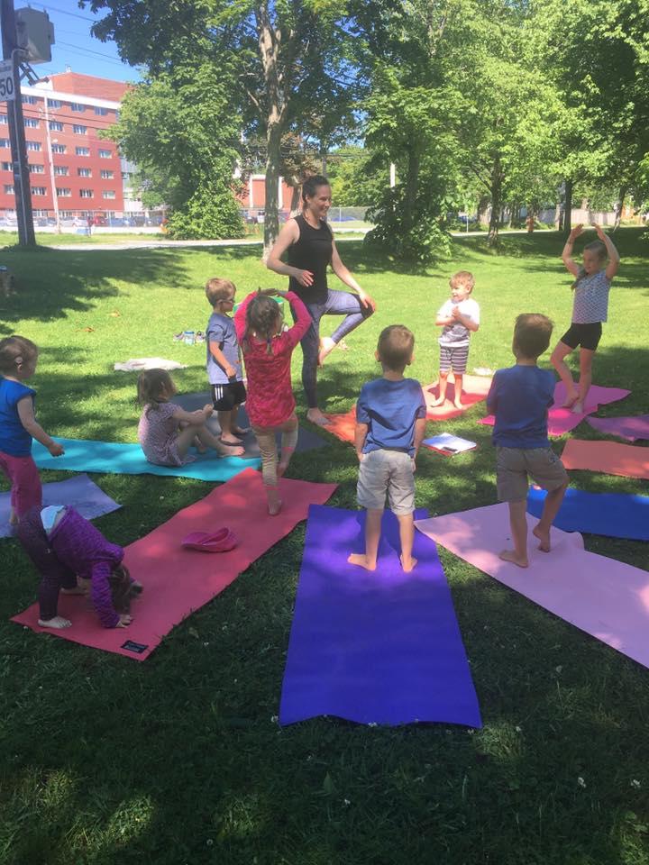 Zachary and his friends doing yoga on the grass in a park