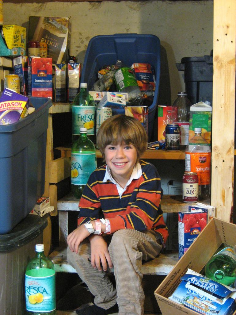 Drew age 8 with bottles he collected for Seva