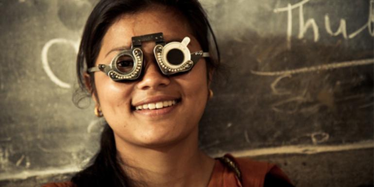 Nepali girl wearing glasses and smiling at camera