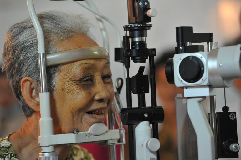 Cambodian woman having eyes examined