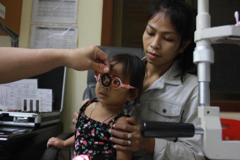 Ophthalmologist examining Sophara in Cambodia