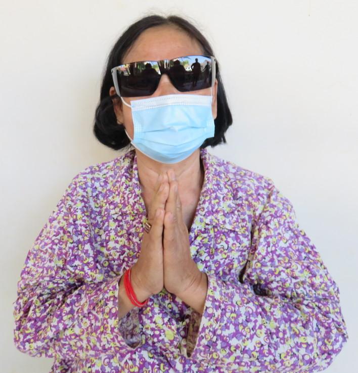 Mrs. Leong in Cambodia post-op namaste hands