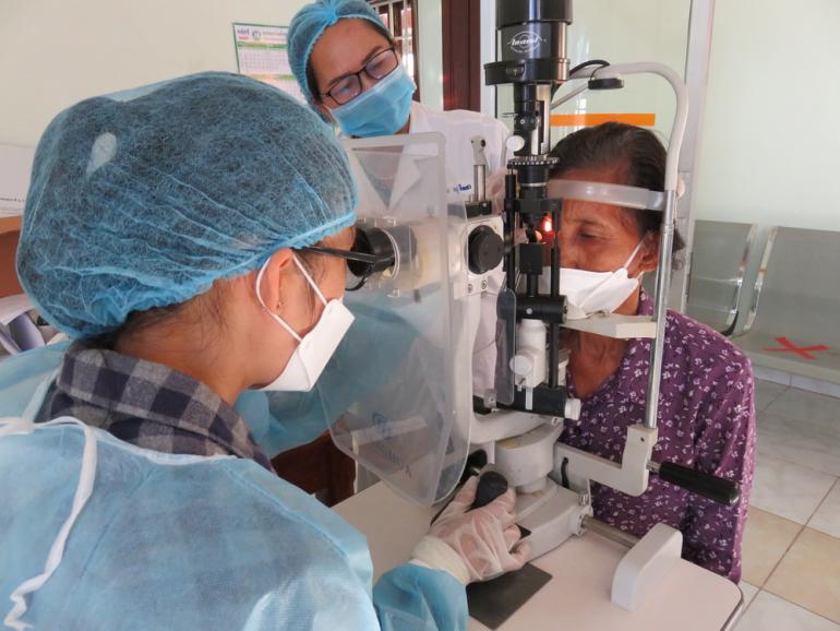 Dr. Sorina post-op eye examination on Mrs. Loeng in Cambodia