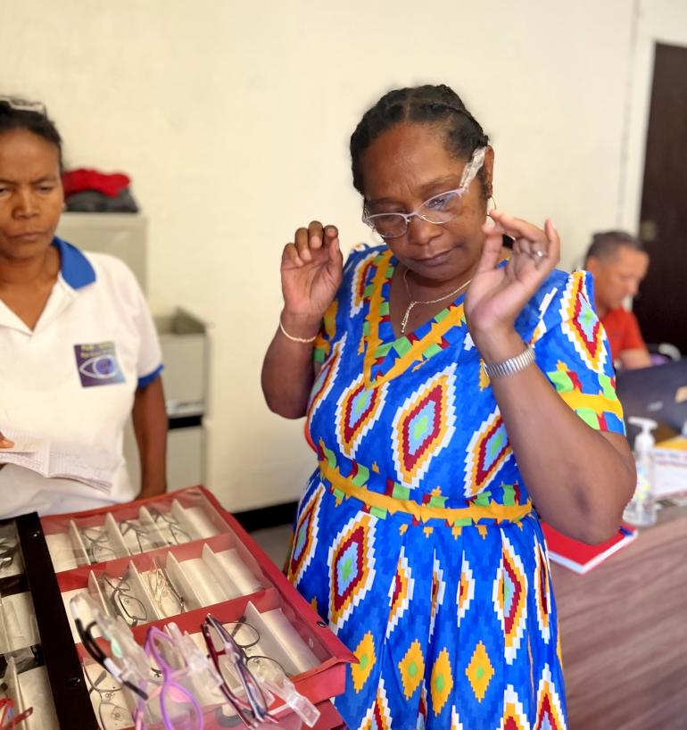 Marie Amee trying on reading glasses at CEC in Ambilobe Madagascar