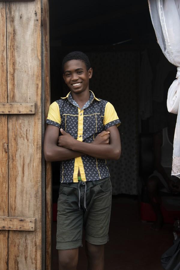 15-yr-old Jaonah leaning against the doorway of his home in Sambava Madagascar