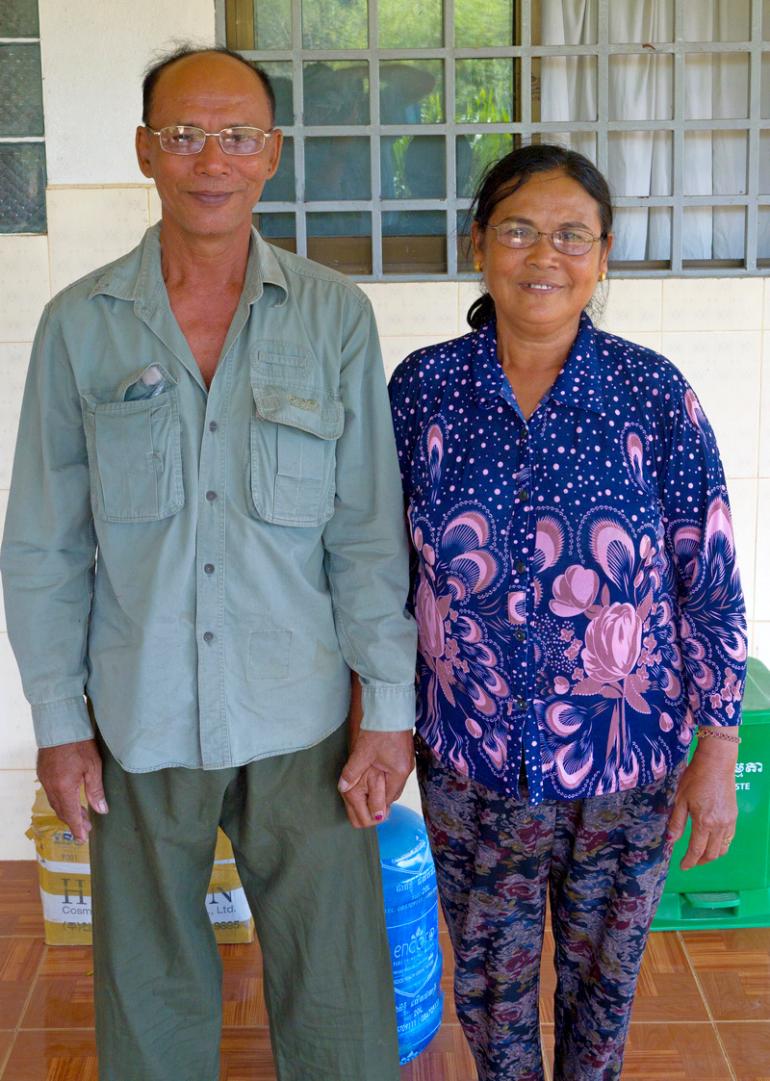 Cambodian Couple Sat Sari and Kouoy Long holding hands and wearing glasses 