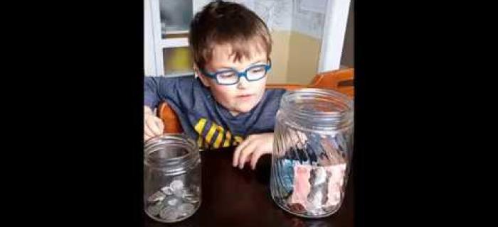 Zachary explaining his donation jar for Seva Canada