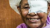 women with bandage over her right eye smiling at camera