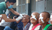 Cambodian patients having bandages removed after cataract surgery 