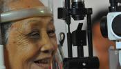 Cambodian woman having eyes examined
