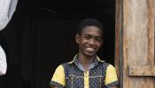 Banner 15-yr-old Jaonah leaning against the doorway of his home in Sambava Madagascar