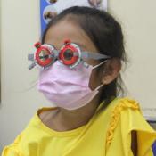 Cambodian girl having her vision tested