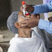 Ethiopian woman receiving medicine - eye drops