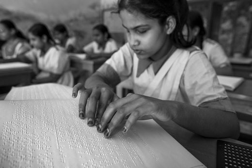 Blind girl reading braille photograph by Larry Louie